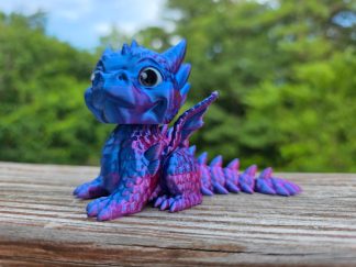 Red flexi dragon, a fully articulated 3D printed dragon with ridged scales and a poseable tail, posed upright.